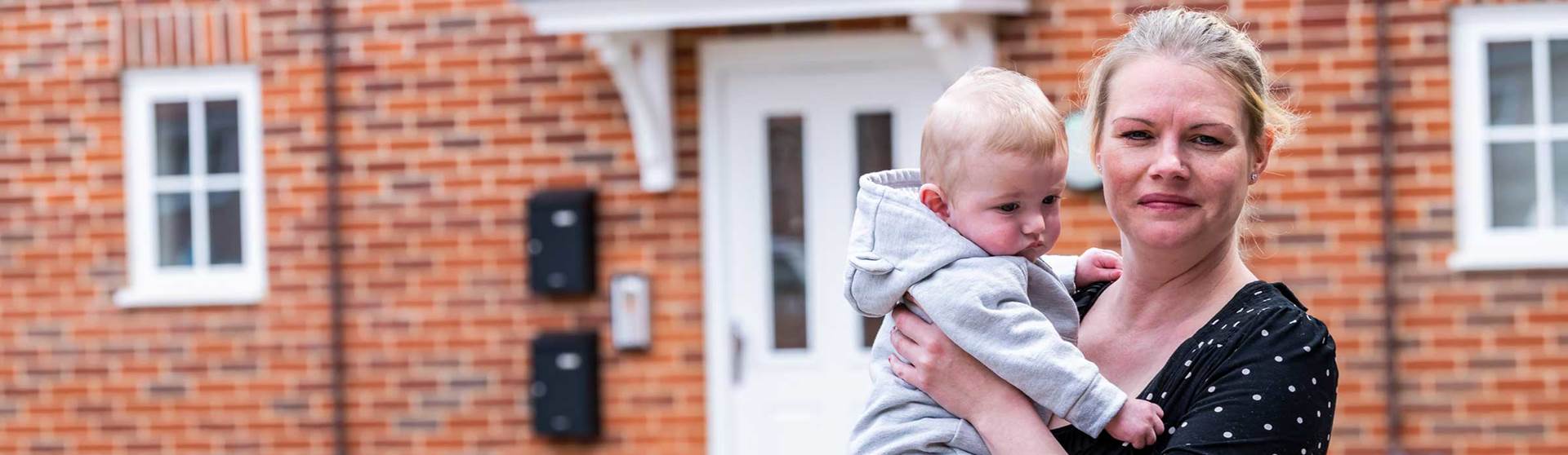 woman and baby outside home