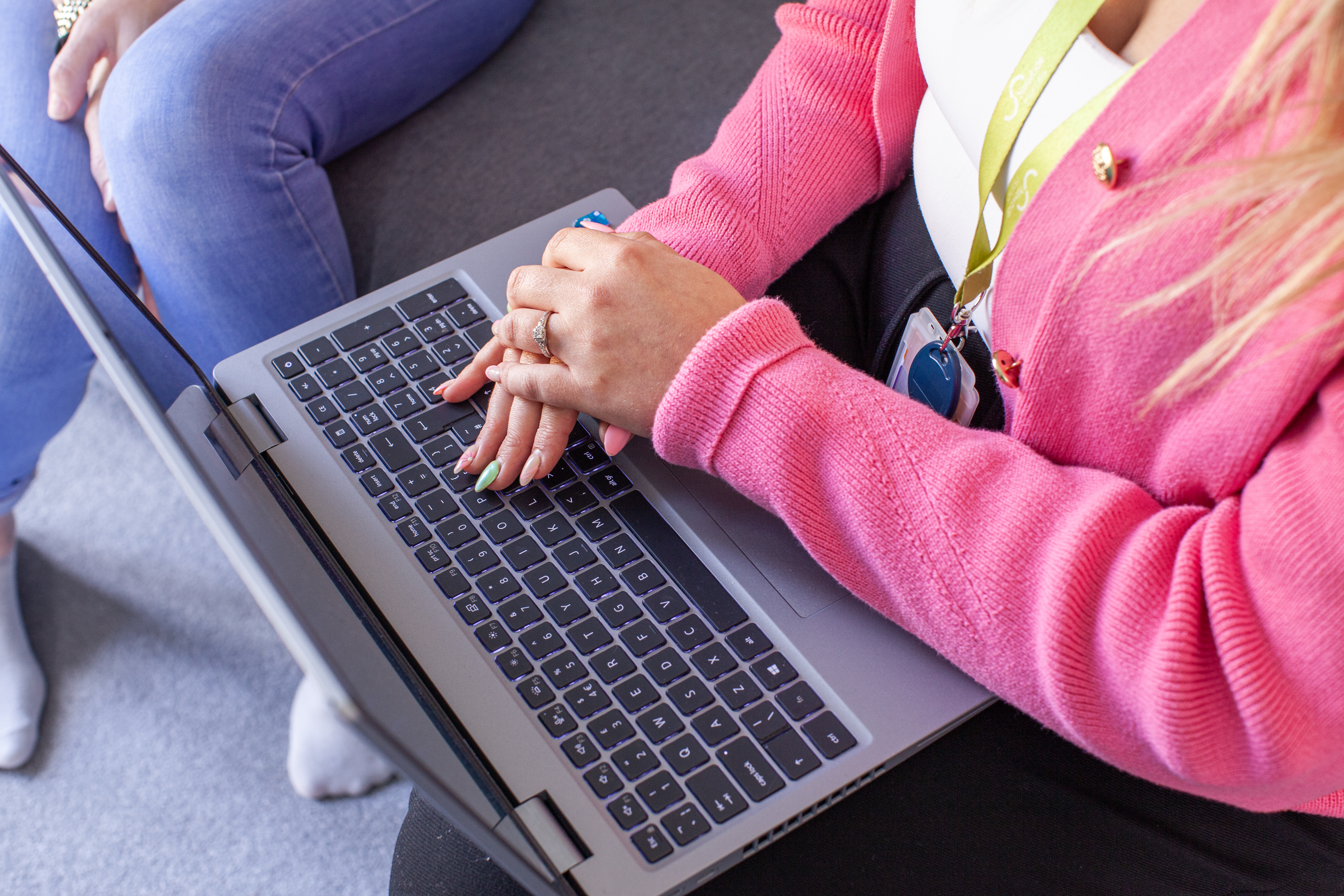 Flagship housing team member at a laptop with a tenant